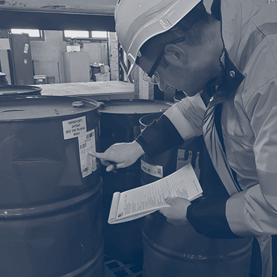 Environmental Health and Safety Audit - Technician Inspecting the labeling on a drumm